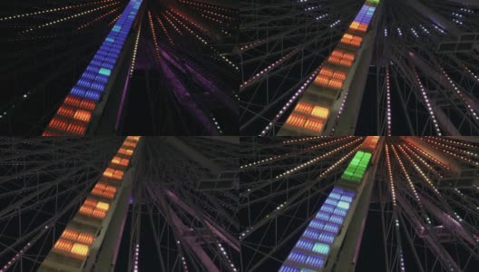摩天轮的夜景。明亮的彩色灯。高清在线视频素材下载