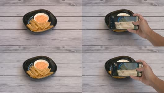 俯视图男子用智能手机拍摄餐盘上的食物高清在线视频素材下载