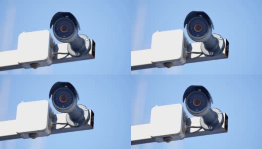 安全摄像头和城市视频监控，防盗防盗，小偷对抗户外的蓝天高清在线视频素材下载
