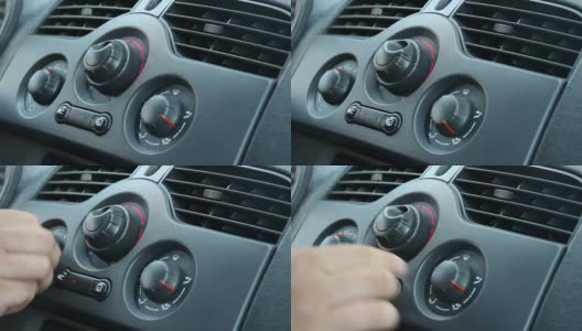 在汽车中，男性加热开关的特写高清在线视频素材下载