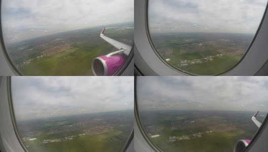 从窗口望向地面、天空和机翼的乘客视角高清在线视频素材下载