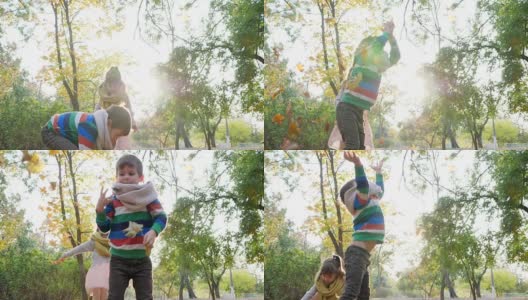在秋天的公园里，欢快的孩子们在大自然的背光下玩耍，把黄叶抛向空中高清在线视频素材下载