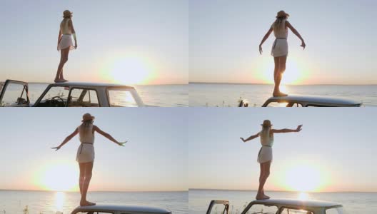 快乐的旅行，女孩站在车顶，双手张开，欣赏日落，自由的快乐在海边，年轻女子站在举起的手高清在线视频素材下载