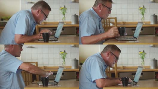 一个男人在家里用笔记本电脑工作，公平地搓手，对结果很满意，好消息。远程雇佣，老年人，自由职业者高清在线视频素材下载