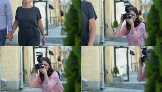 女人拿着相机在大街上偷拍著名演员夫妇，偷拍狗仔队高清在线视频素材下载