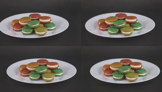 甜美可口的彩色杏仁饼干放在白色的盘子里就可以吃了高清在线视频素材下载