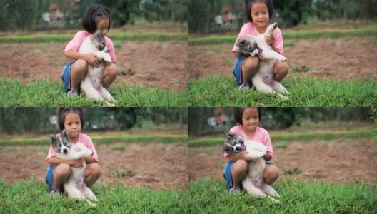 小女孩和一只狗在乡下玩耍。高清在线视频素材下载
