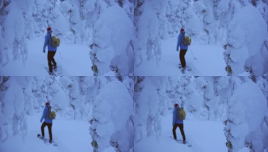一个穿着冬衣的人在冰冻的环境中拿着滑雪板慢慢地走。采用针高清在线视频素材下载