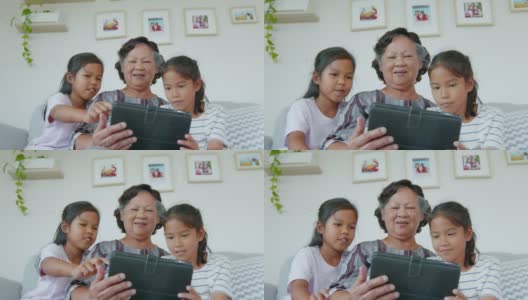 在客厅里，两个孙女一起帮奶奶用ipad。高清在线视频素材下载