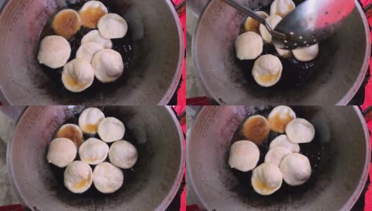 用热油制作当地街头小吃puri。制作美味的孟加拉Luchi或油炸面包。它也被称为印度穷人。高清在线视频素材下载