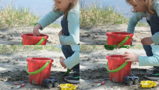 专心的小孩在河边玩他的玩具桶和铲子。高清在线视频素材下载