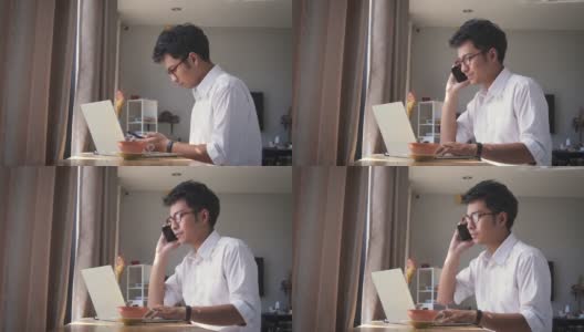 年轻的亚洲商人坐在家里的客厅里用智能手机高清在线视频素材下载