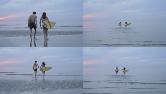 早上，亚洲夫妇在海滩上玩冲浪高清在线视频素材下载