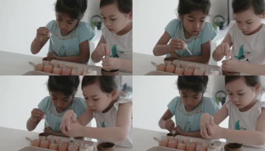 混合儿童在重复使用蛋壳中种植幼苗，蒙特梭利家庭教育，可持续的生活理念高清在线视频素材下载