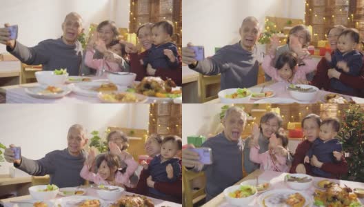 亚洲家庭用手机自拍在晚餐时，庆祝圣诞假期在公寓高清在线视频素材下载