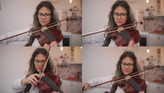 一个在家拉小提琴的年轻音乐家高清在线视频素材下载