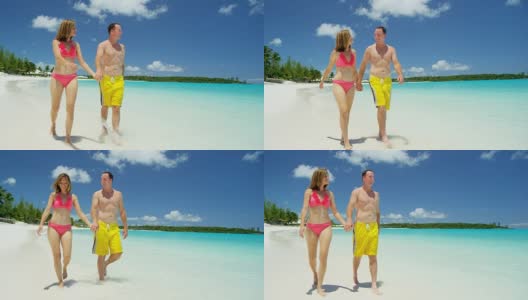穿着泳衣的白人夫妇在沙滩上手拉手高清在线视频素材下载