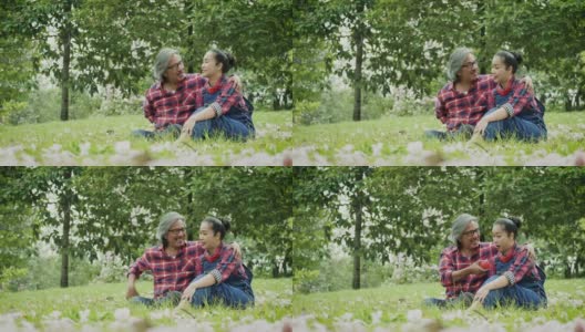 快乐的亚洲成熟夫妇放松和花时间一起在公园户外高清在线视频素材下载