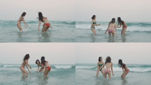 一群快乐的女孩朋友在沙滩上玩水。美丽的亚洲女孩在暑假。庆祝和放松的概念。高清在线视频素材下载
