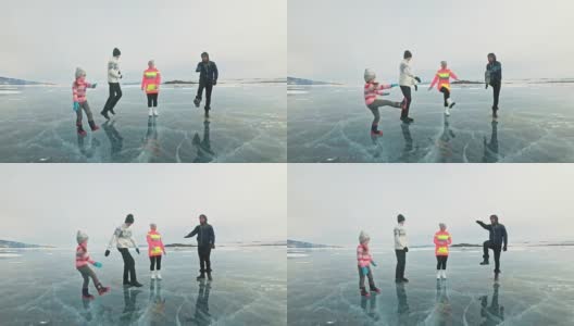一家人在大自然的冰上进行体育锻炼。父亲在冬天训练他的家人。母女和儿子看着他的训练课。孩子们试着重复。运动前的标准拉伸。高清在线视频素材下载