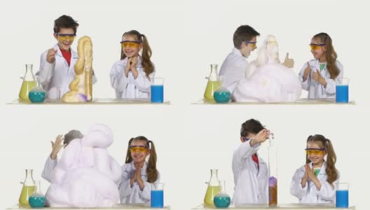 两个美丽，可爱的化学家孩子做有趣和成功的实验孤立在白色背景，慢动作高清在线视频素材下载