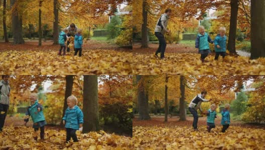 童年时光:少年和孩子们在公园里与秋叶嬉戏高清在线视频素材下载
