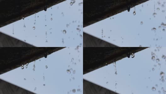 水滴从屋檐落下的慢动作高清在线视频素材下载
