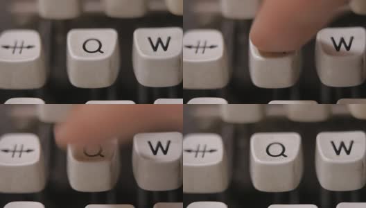 用手指在老式老式打字机上敲字母Q。高清在线视频素材下载