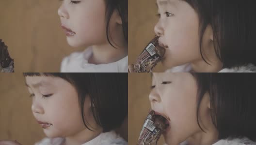 小女孩在吃巧克力冰淇淋高清在线视频素材下载