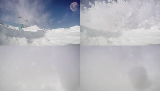 一个滑雪者滑下斜坡的慢动作动态镜头:雪花飞进了摄像机高清在线视频素材下载