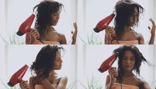 深色头发的女人用毛巾在家里用吹风机烘干头发高清在线视频素材下载