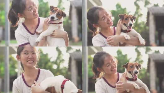 亚洲家庭十几岁的女孩玩好玩的她的宠物杰克罗素梗狗在花园在夏天的早晨高清在线视频素材下载