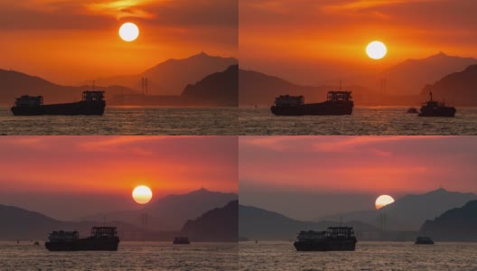 4K延时宽拍摄日落与移动的云在山脉和水上运输物流船船通过海湾。高清在线视频素材下载