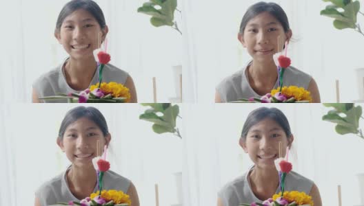 快乐的亚洲女孩花插花(由香蕉叶和花漂浮在河里祈祷和感谢你)一起在家，为晚上的时间做准备。高清在线视频素材下载
