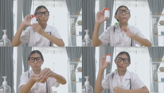 亚洲药剂师女孩在家里通过视频电话解释药瓶，封锁生活方式的概念。高清在线视频素材下载