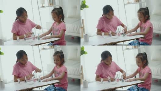 快乐的亚洲儿童涂指甲油，同时放松在一个家，生活理念。高清在线视频素材下载