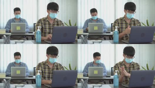 两名商人戴着防护口罩和同事在办公室使用酒精凝胶洗手液的4k视频高清在线视频素材下载
