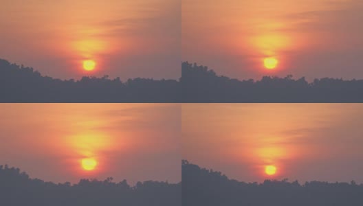 黄色的太阳照耀着山顶上红色的天空。高清在线视频素材下载