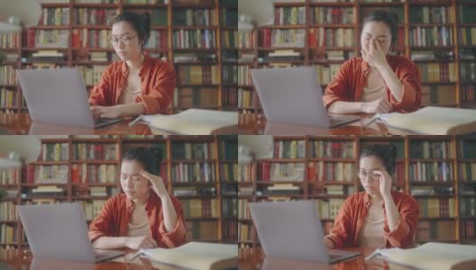 疲惫的女作家摘下眼镜，在笔记本电脑上休息，眼睛疲劳高清在线视频素材下载