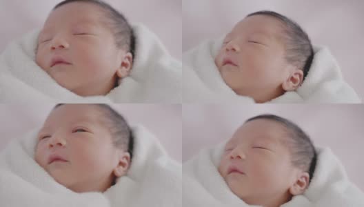 快乐亚洲可爱的儿子新生婴儿睡觉。新出生的。高清在线视频素材下载