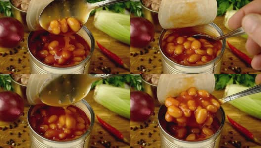 厨师用汤匙从厨房木板上的金属罐中取出番茄酱炖豆。高清在线视频素材下载