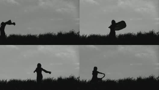 年轻女子戴着头巾在草地上跳舞高清在线视频素材下载