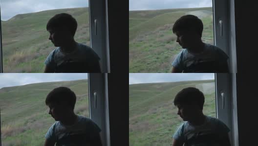 那个男孩坐在窗台上望着窗外高清在线视频素材下载