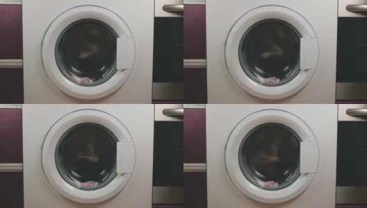 洗衣机洗脏衣服的录像。家用电器的概念高清在线视频素材下载
