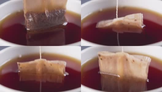 把一个红茶包泡在热水里，放在一个白色的茶杯里高清在线视频素材下载