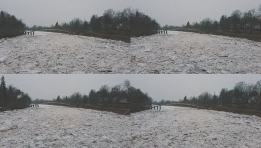 巨大的冰块漂流在拉脱维亚的食人河。空中龙拍摄雪城日。春天这条河上的交通堵塞。一大群移动的冰块高清在线视频素材下载