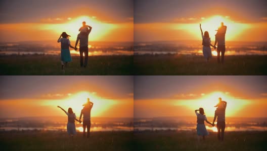 快乐的家庭户外-妈妈，爸爸和小儿子散步到日落在夏季草地高清在线视频素材下载