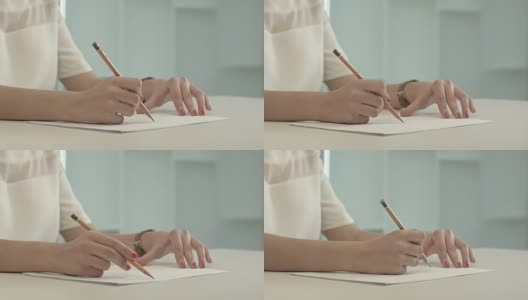 女人用铅笔在纸上写字高清在线视频素材下载