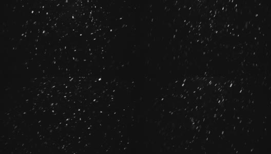 发光的雪粒在空气中飞行火花颜色的黑色背景高清在线视频素材下载