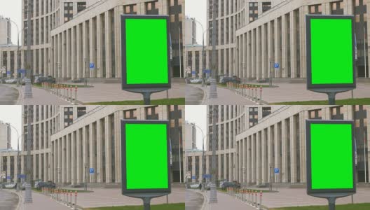 繁忙街道上的一个绿屏广告牌。高清在线视频素材下载